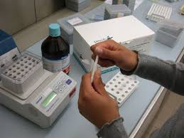 Hands handling sample with bench equipment